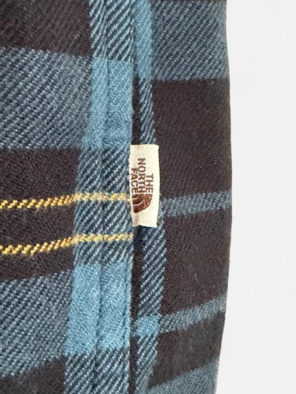 The North Face Blue and Black Plaid Button-Down Shirt with Yellow Stripes